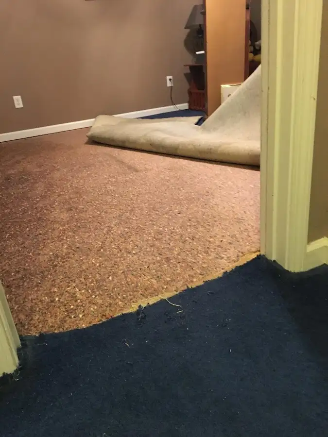 Carpet pad removal revealing water damage during Water Mitigation Services in Summerlin South